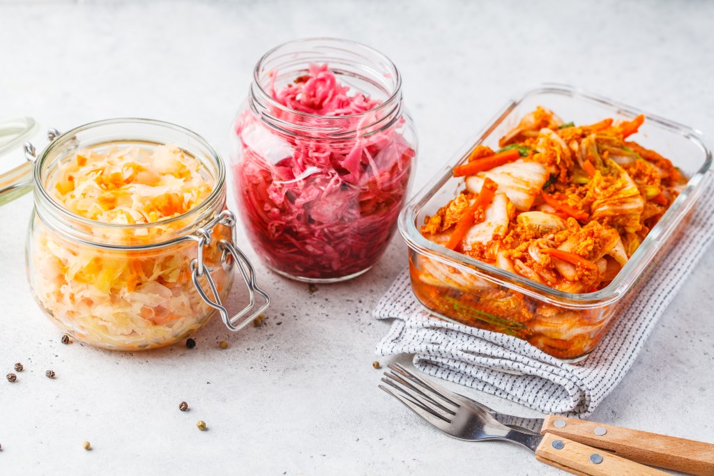 Kimchi and sauerkraut in glass jars 