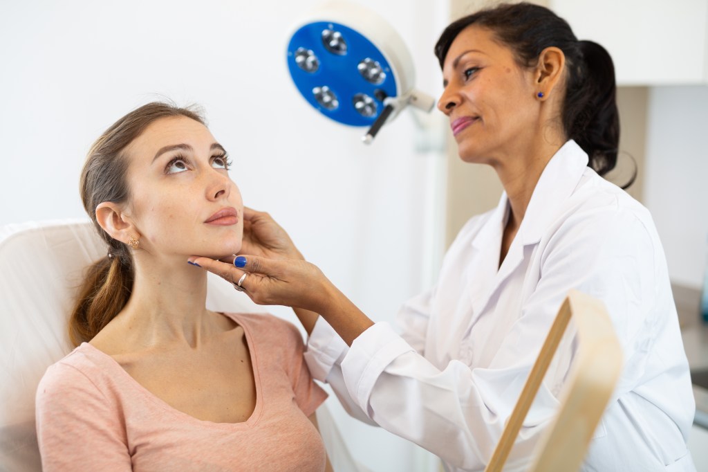 Dermatologist examining skin