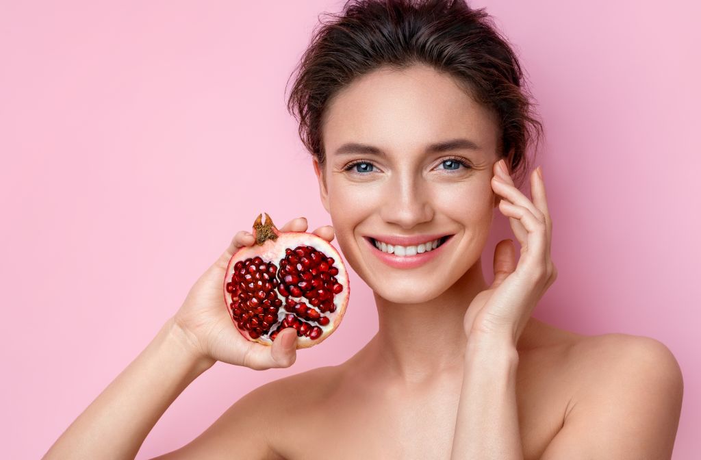 Woman holding a pomegranate