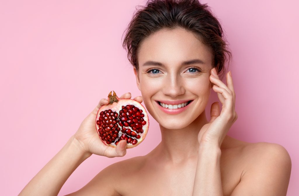 Woman holding a pomegranate