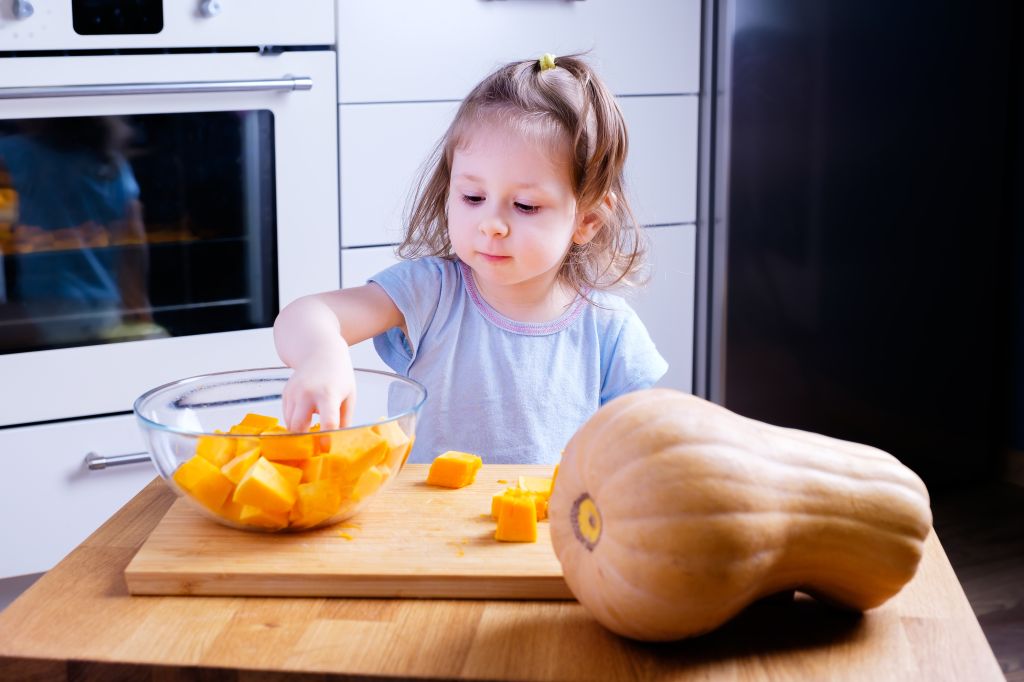 Girl cooking squash 