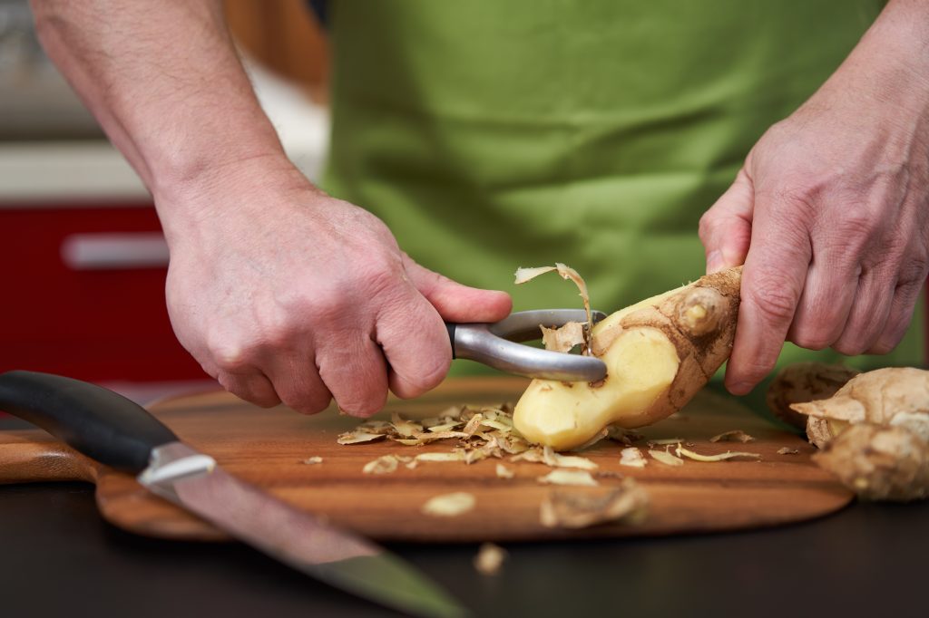 Man peeling ginger 