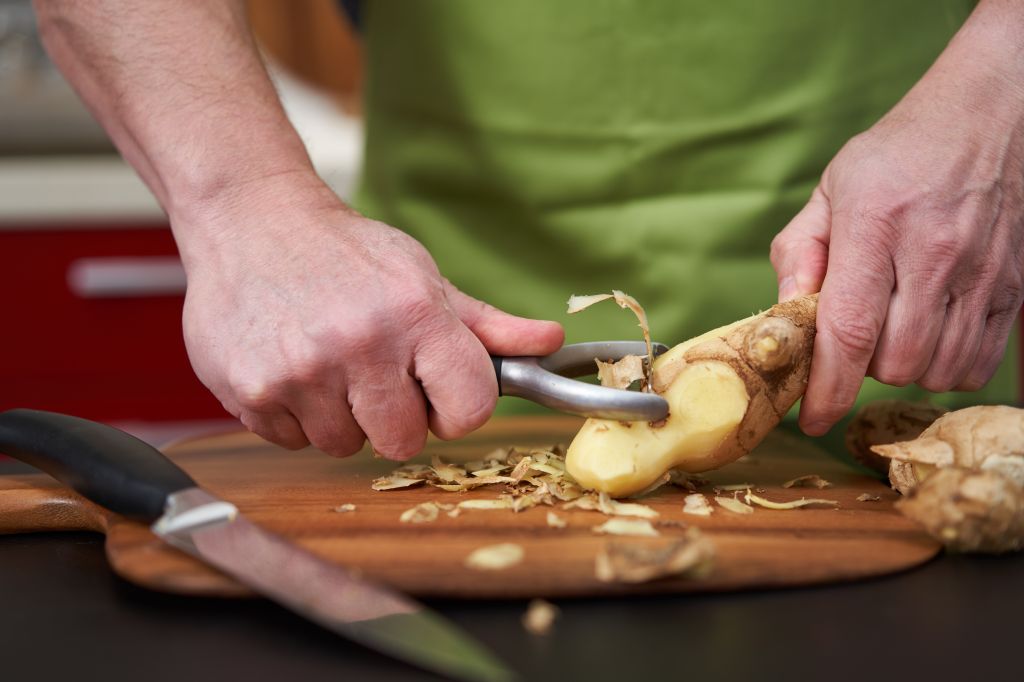 Man peeling ginger