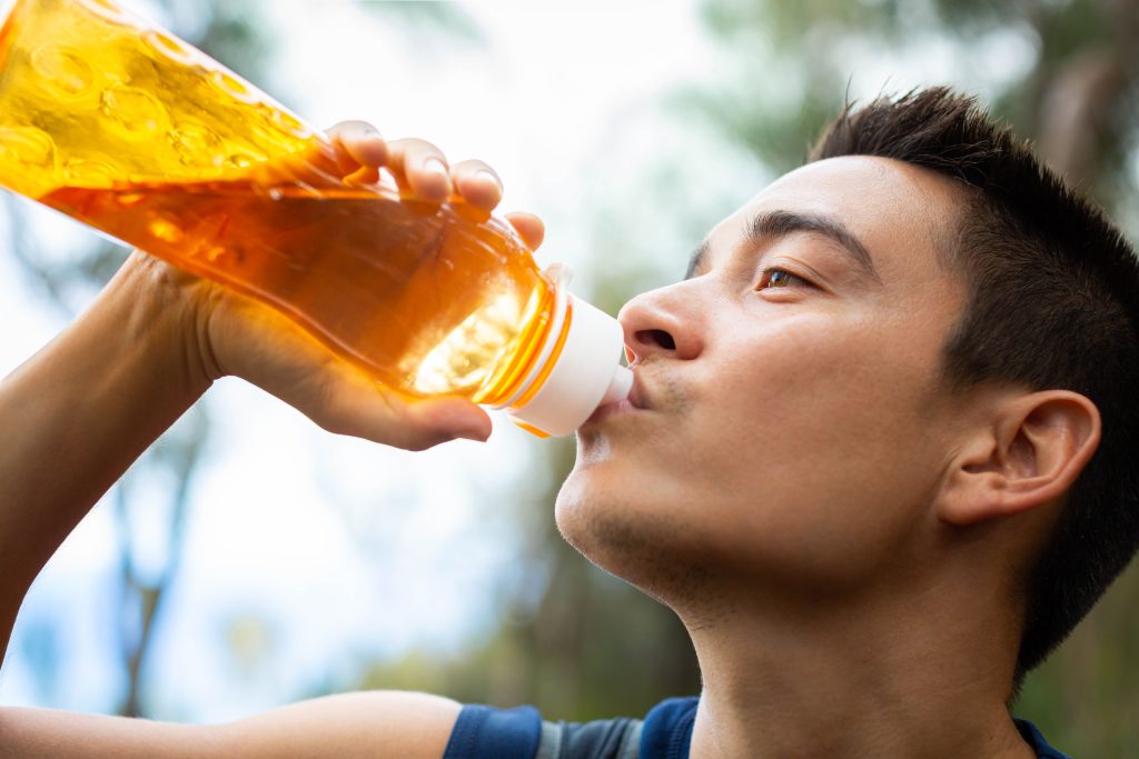 Man drinking electrolyte drink 