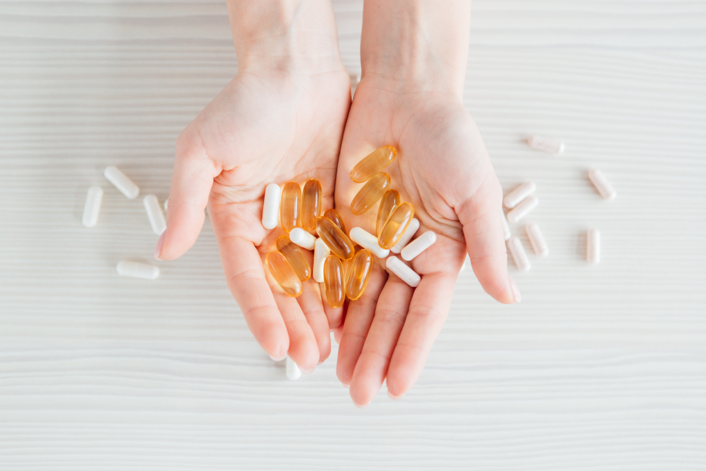Two hands holding dietary supplements