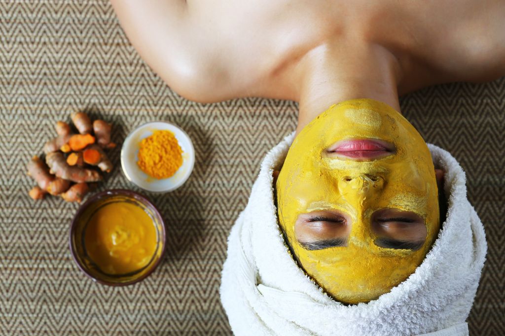 Woman with turmeric facial mask