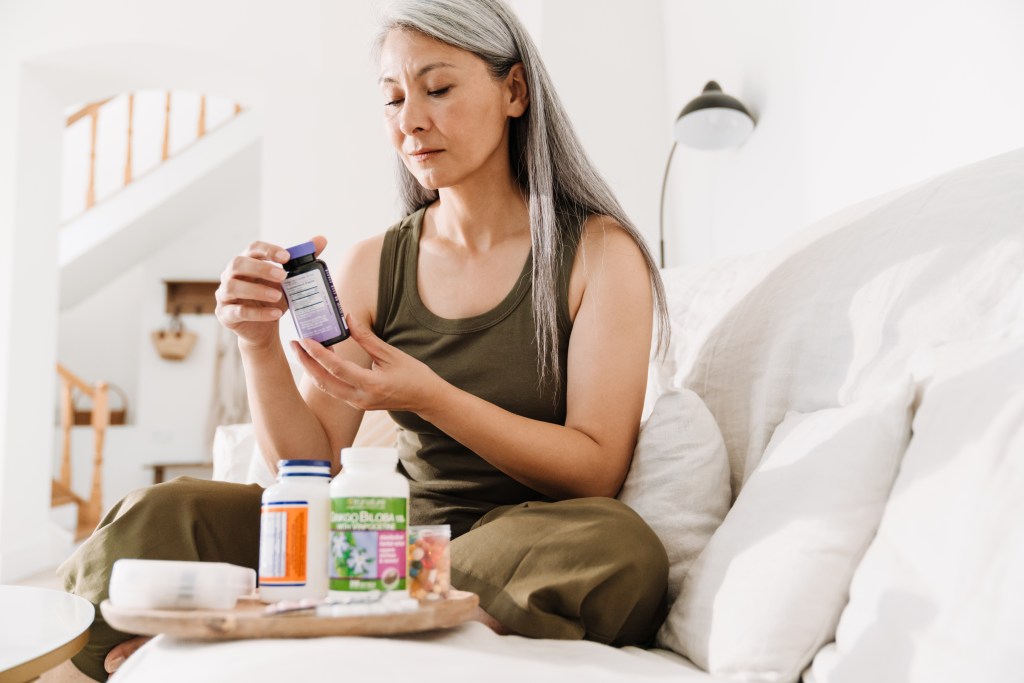 Woman checking supplement labels
