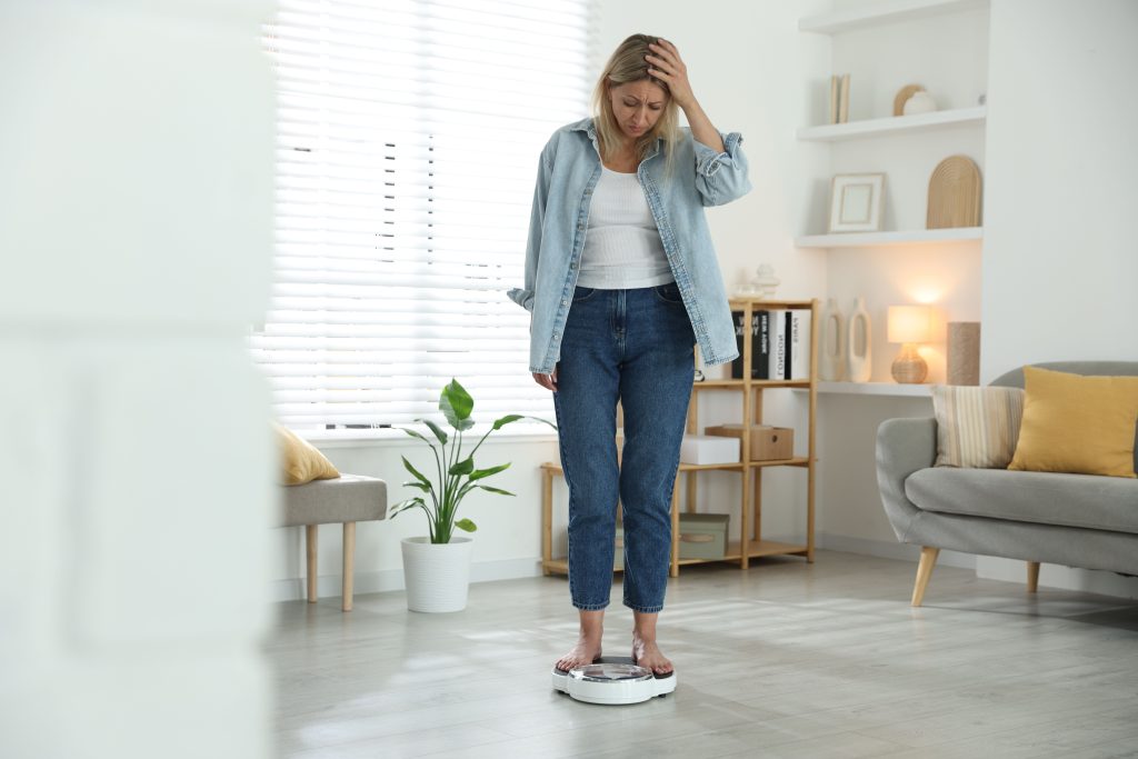 Woman experiencing weight gain from menopause