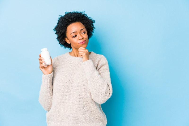 Woman holding supplement bottle