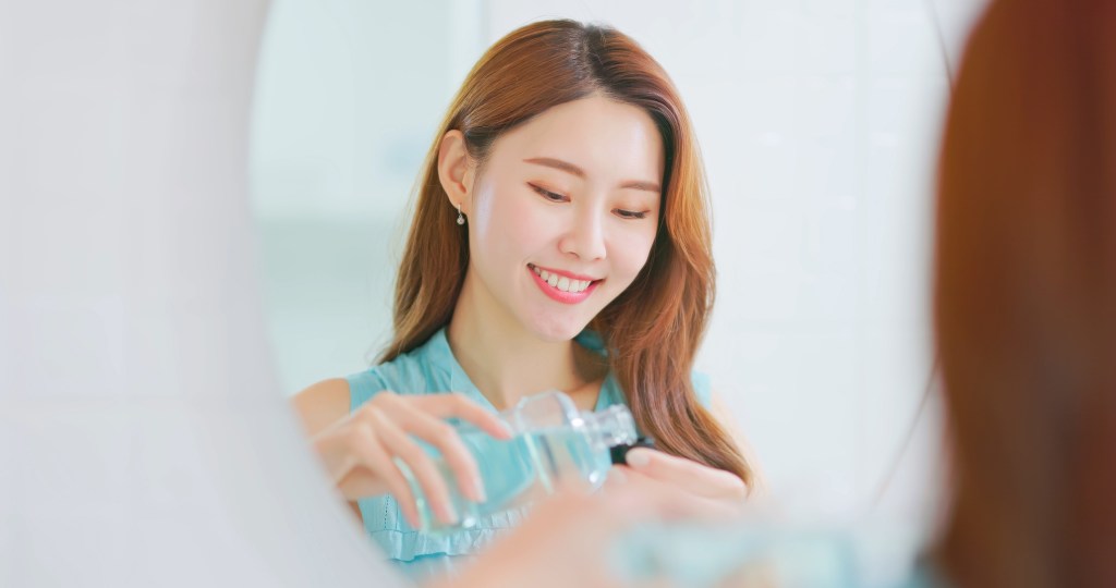 Woman pouring mouthwash