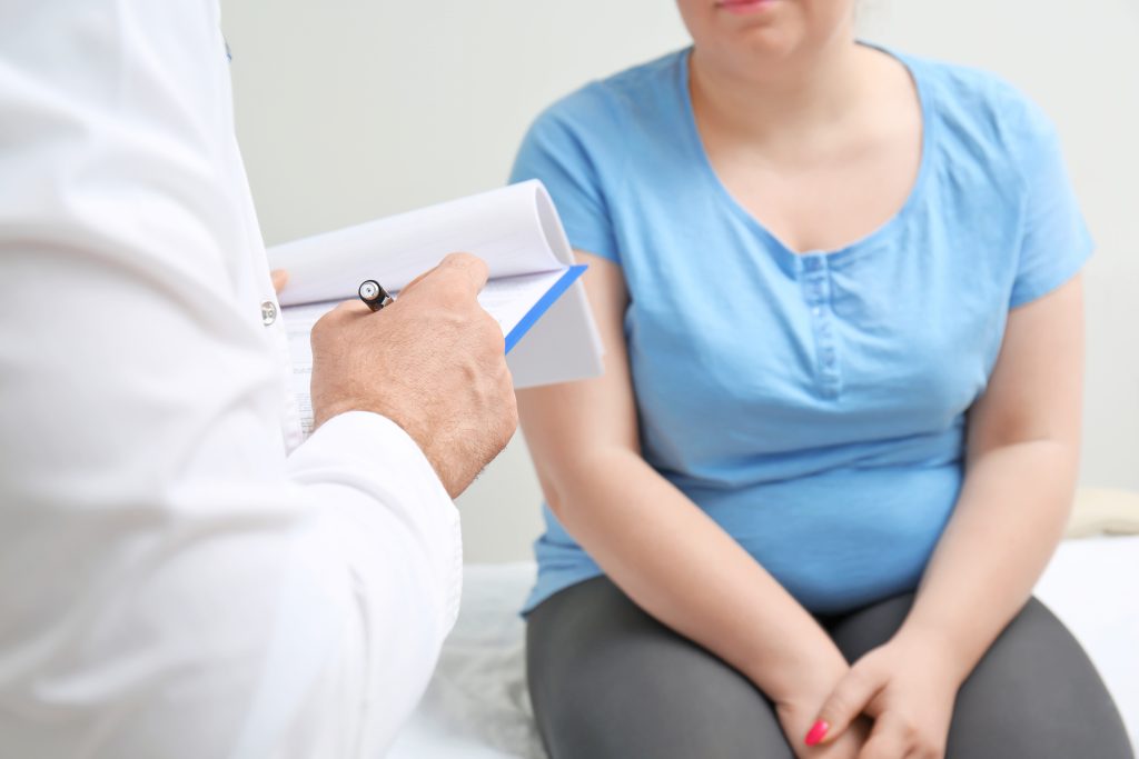 Woman talking to doctor
