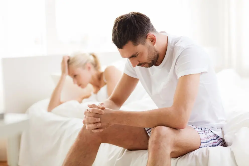 Man sitting on the edge of a bed