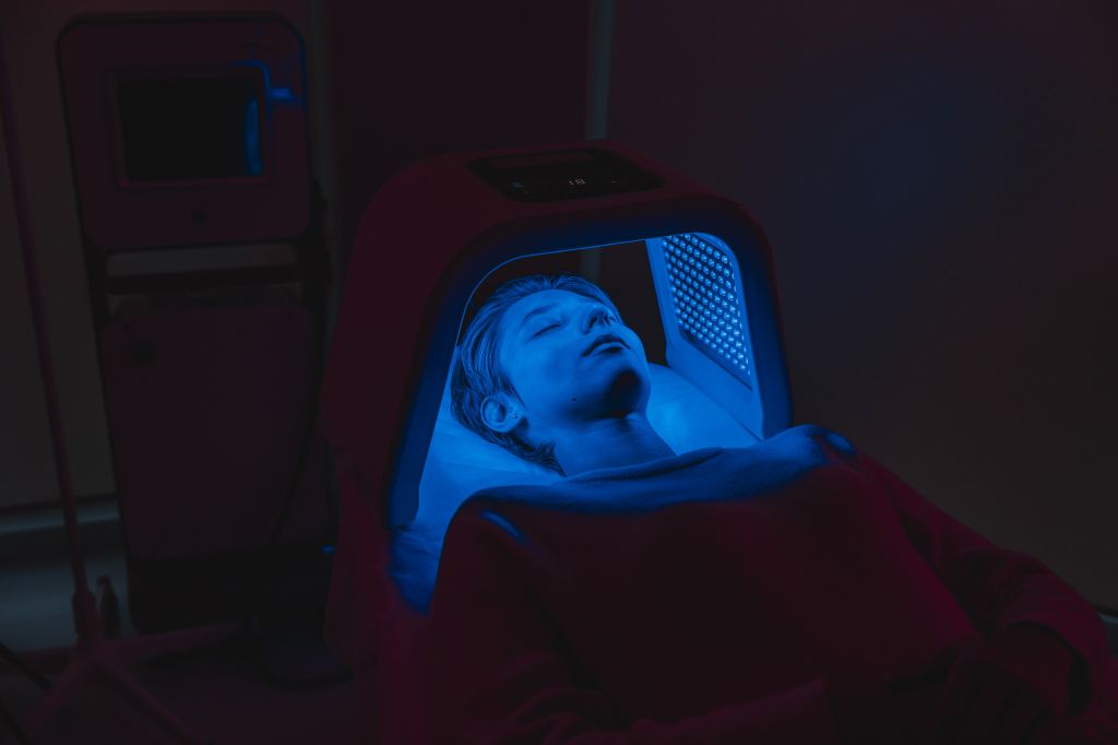 Woman under a blue light lamp  