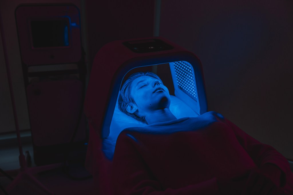 Woman under a blue light lamp