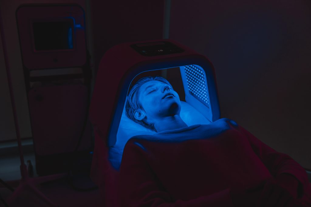 Woman under a blue light lamp
