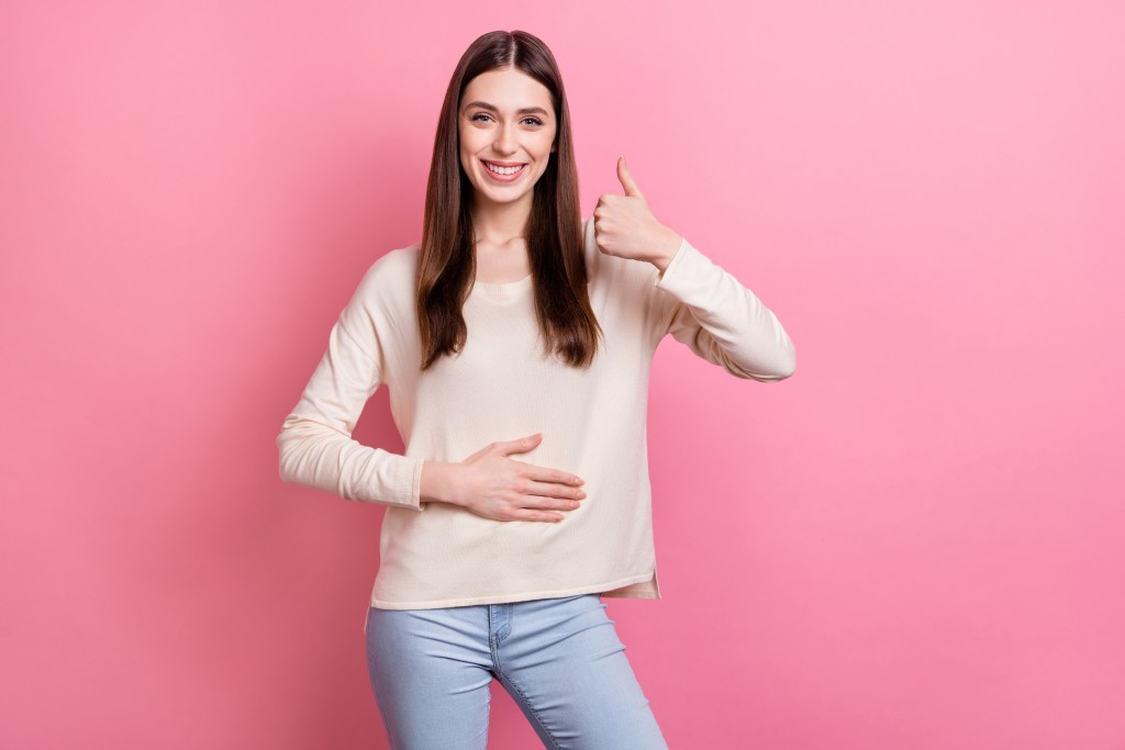 Cheerful woman with a healthy digestive tract