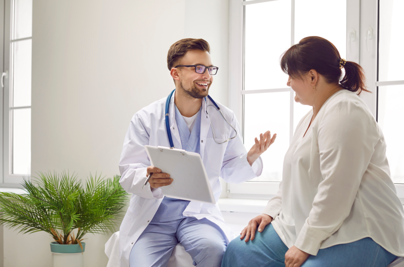 Overweight female talking to a doctor