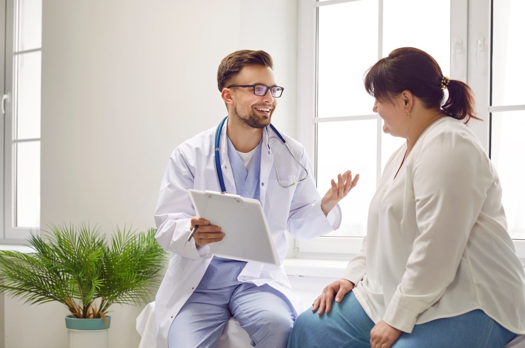 Overweight female talking to a doctor