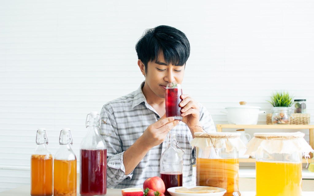 Happy man drinking kombucha