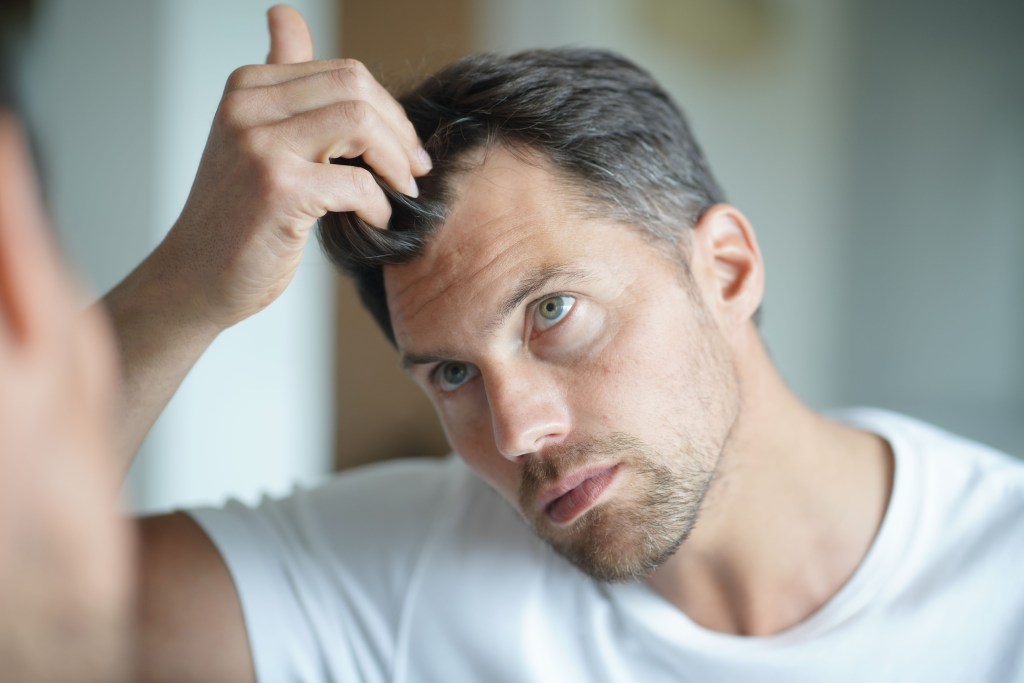 Man finding grey hair