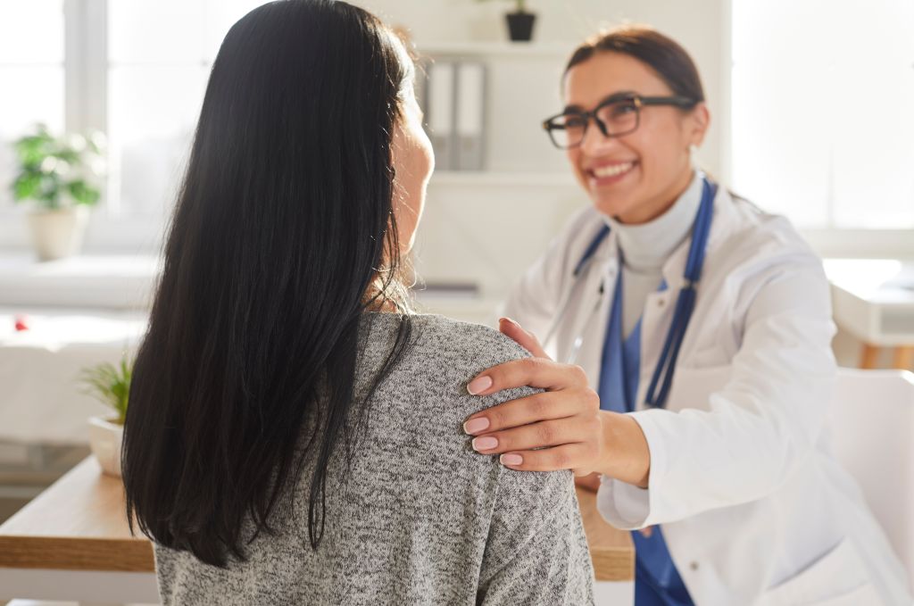 Woman talking to doctor