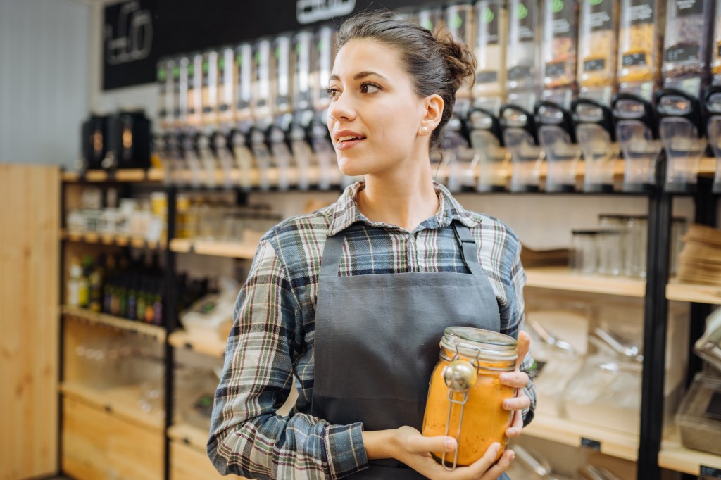 Spice shop employee holding turmeric