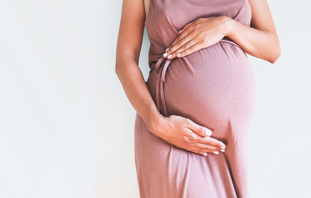 Pregnant women holding belly