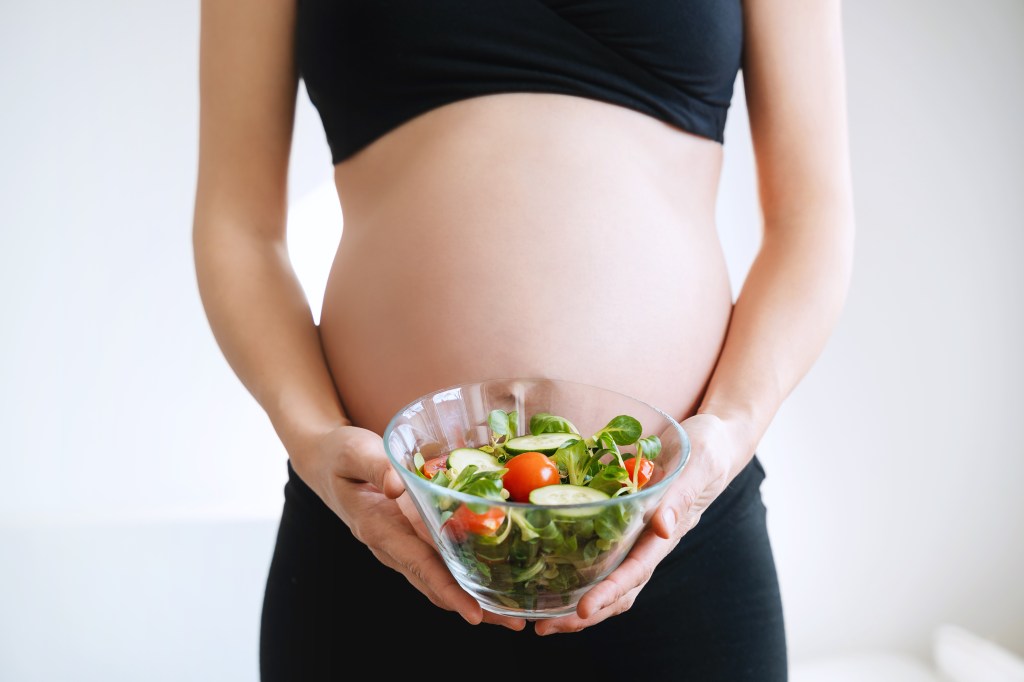 Pregnant woman with folate-rich bowl&nbsp;