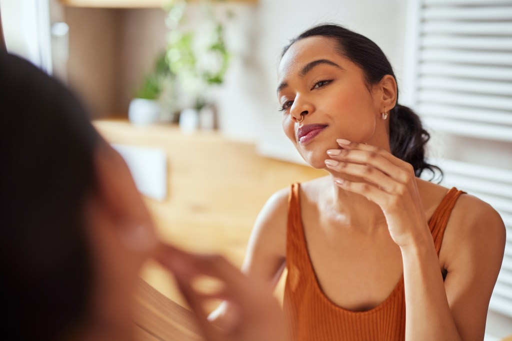 Woman checking her skin  