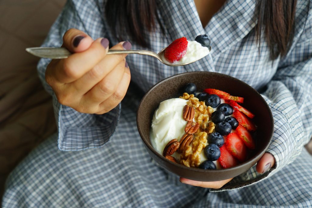 Woman eating a bowl of yogurt