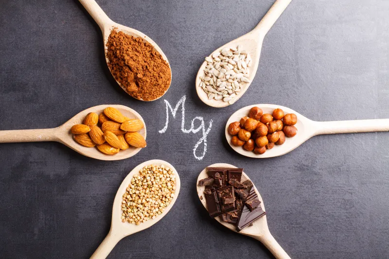 Magnesium-rich foods on wooden spoons
