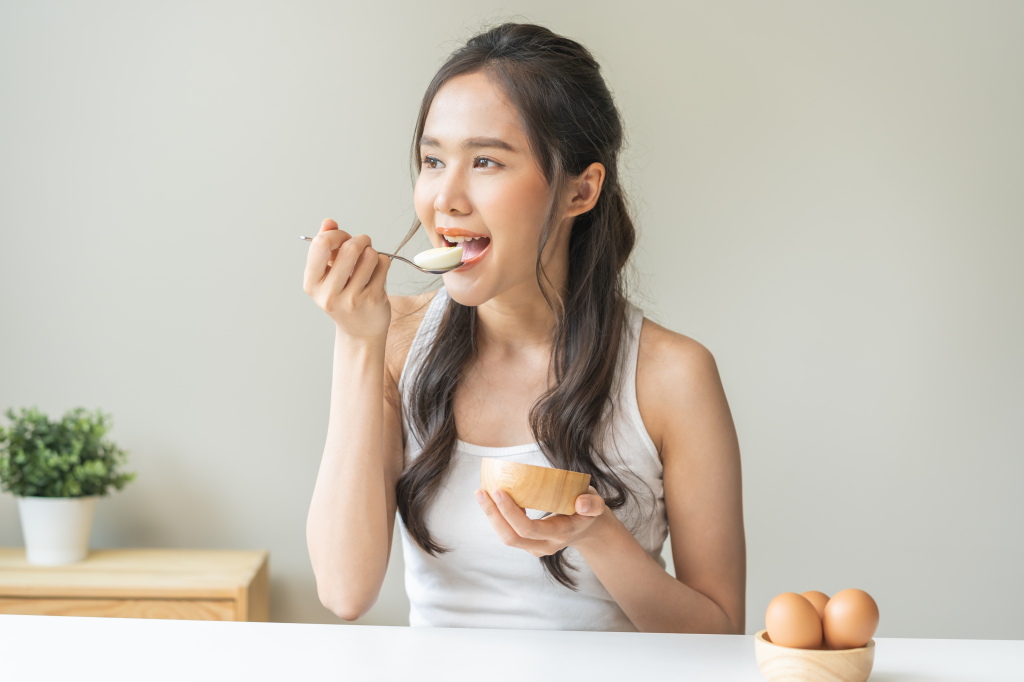 Woman eating an egg