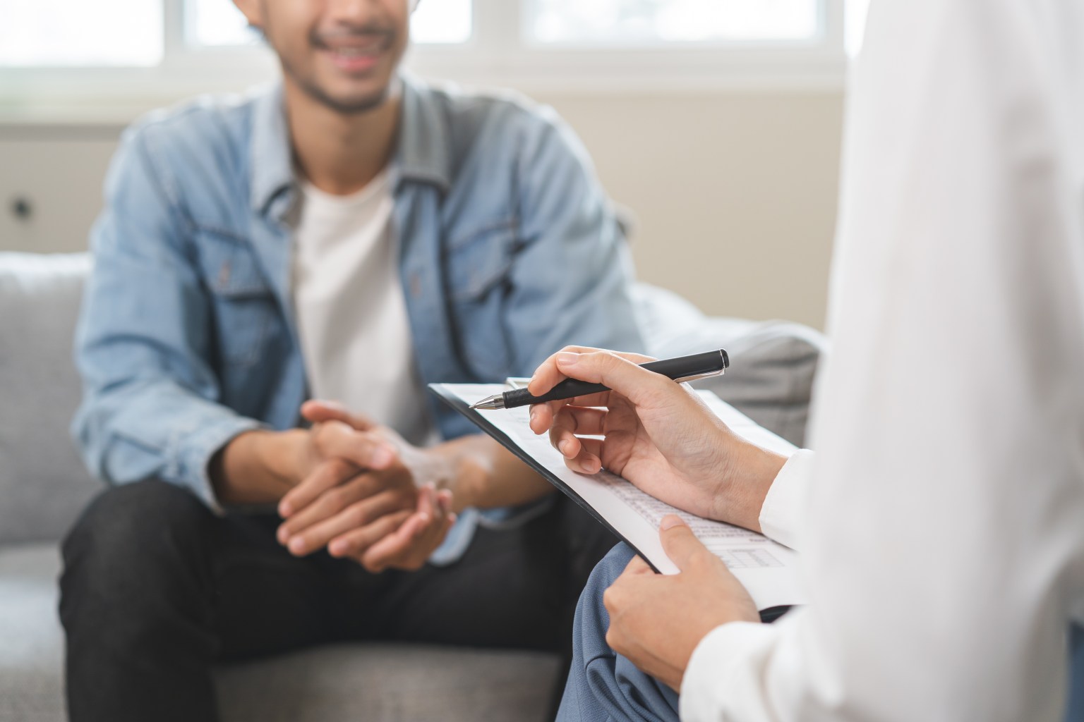 Young man talking to doctor