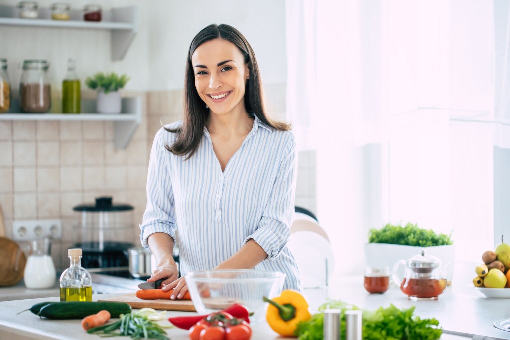 woman making salad with carrots