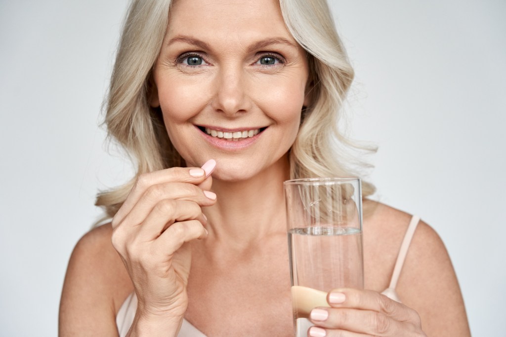Woman taking a supplement