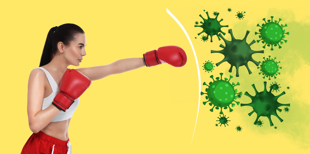 Woman wearing boxing gloves and punching a virus