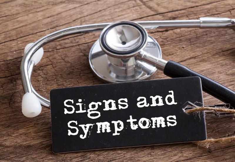 Stethoscope on wood with Signs and Symptoms