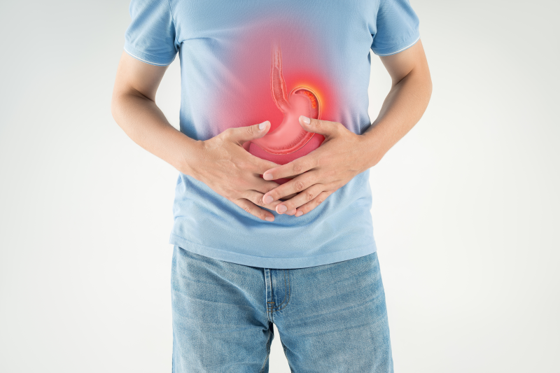 Man holding stomach with highlighted ulcer pain