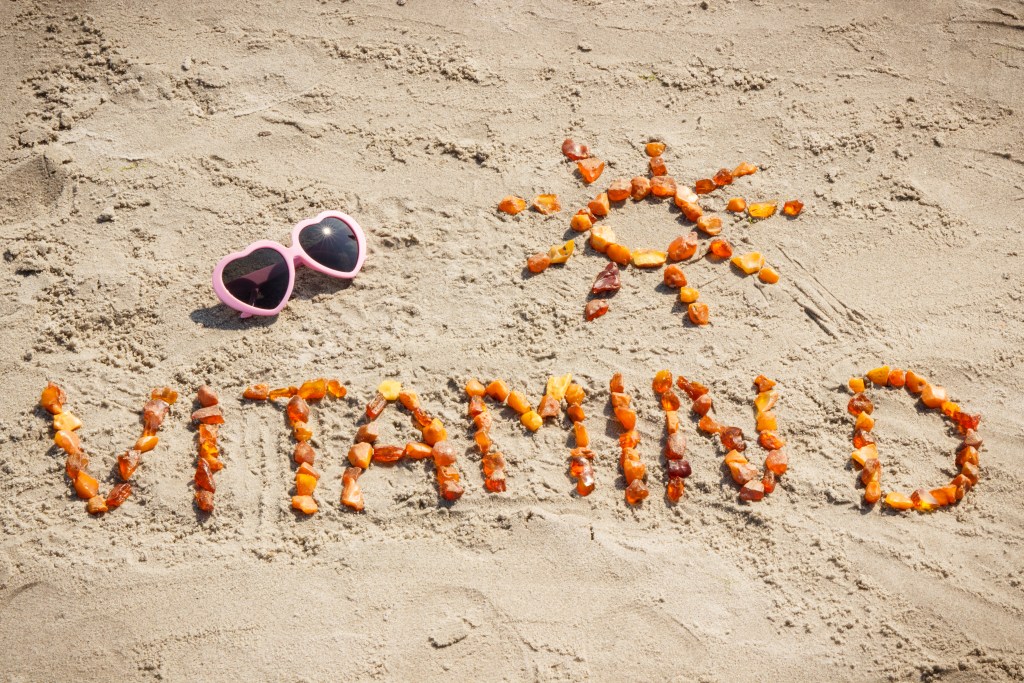 Vitamin D written in sand