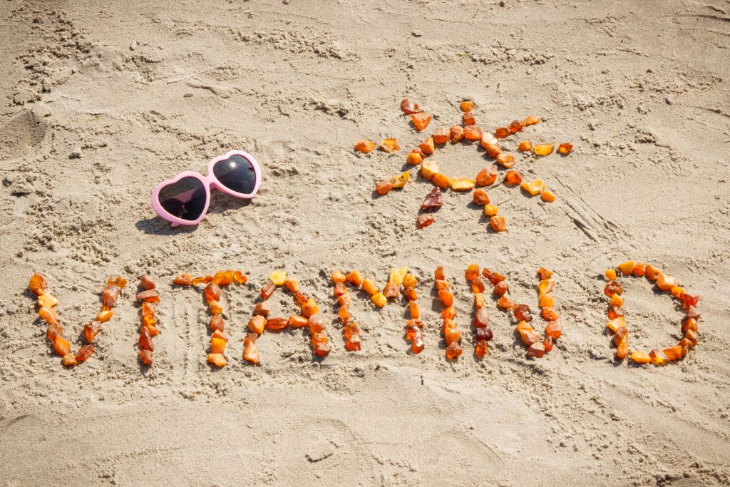 Vitamin D written in sand