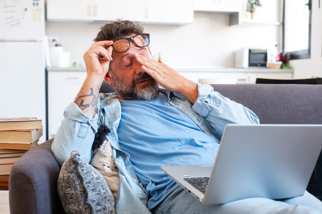 Stressed man at a computer