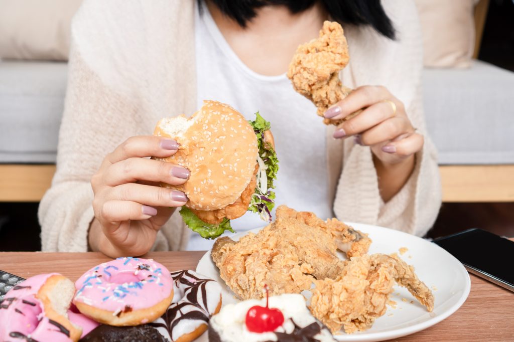 Women binge eating unhealthy food Intermittent Fasting after Gastric Sleeve