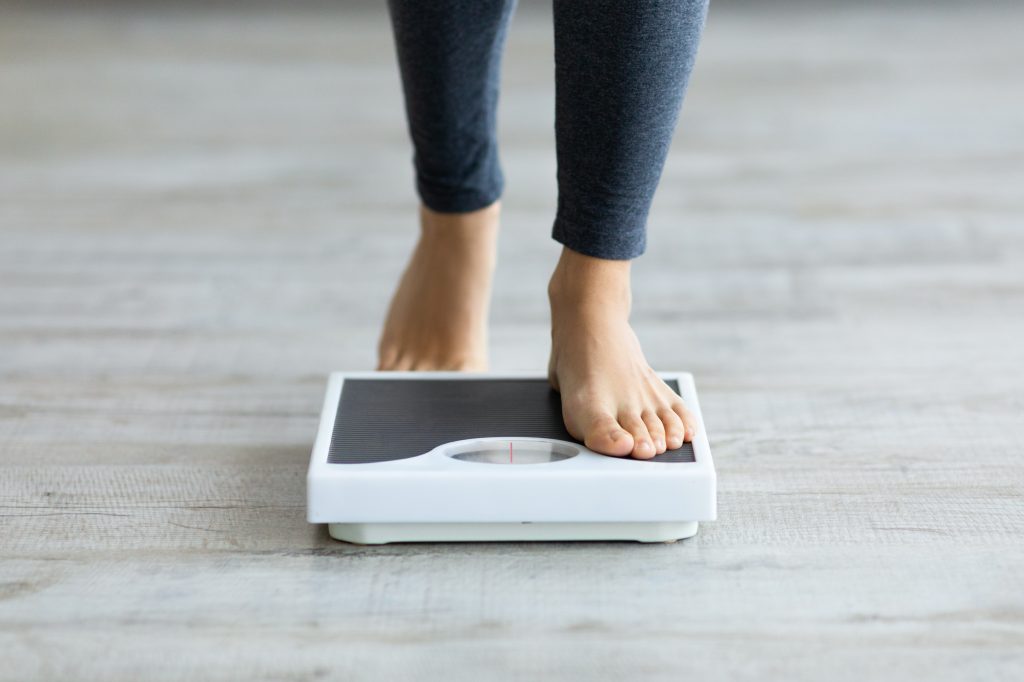Woman stepping on scale 