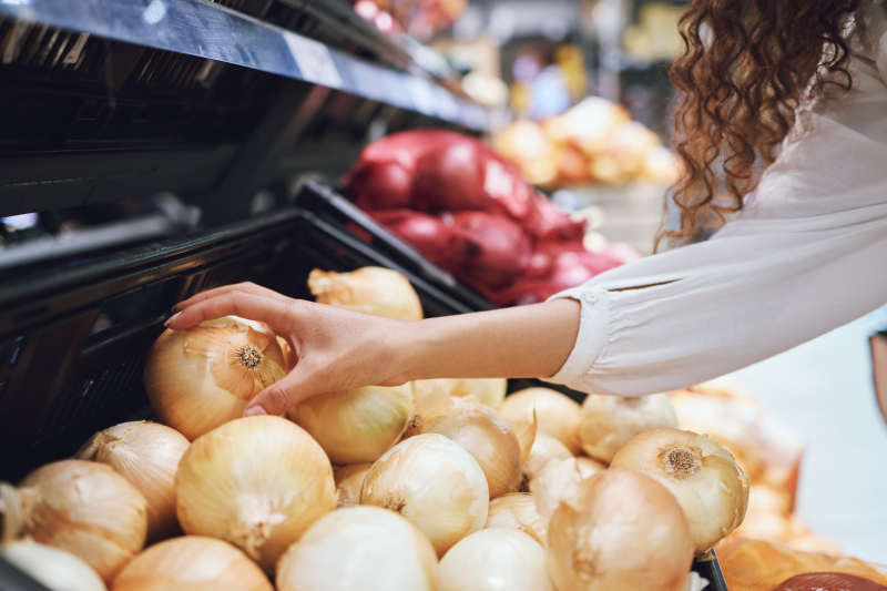 Woman shopping for onions
