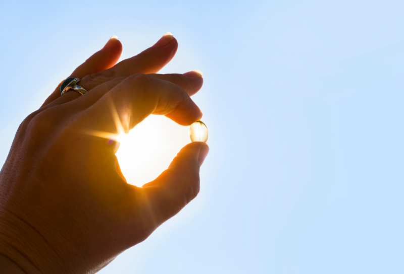 Vitamin D capsule against the sun