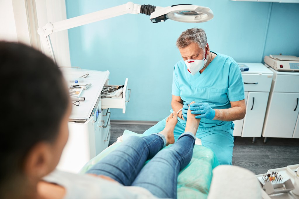 Podiatrist examining toes