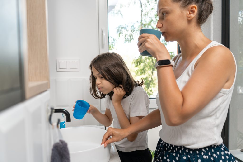 mom and daughter rinsing mouth 