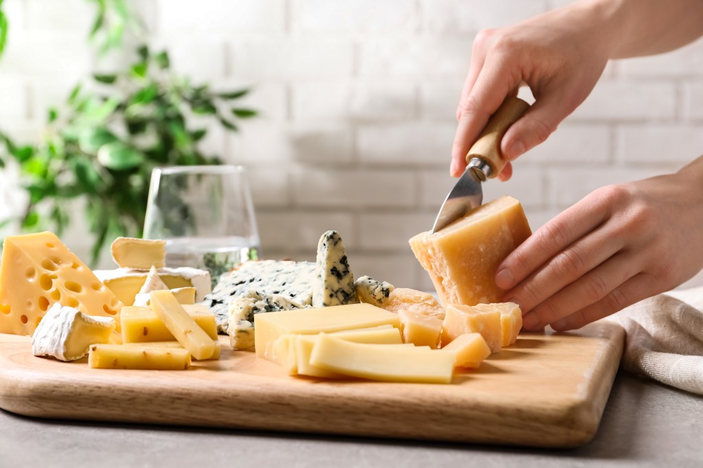 Woman cutting cheese