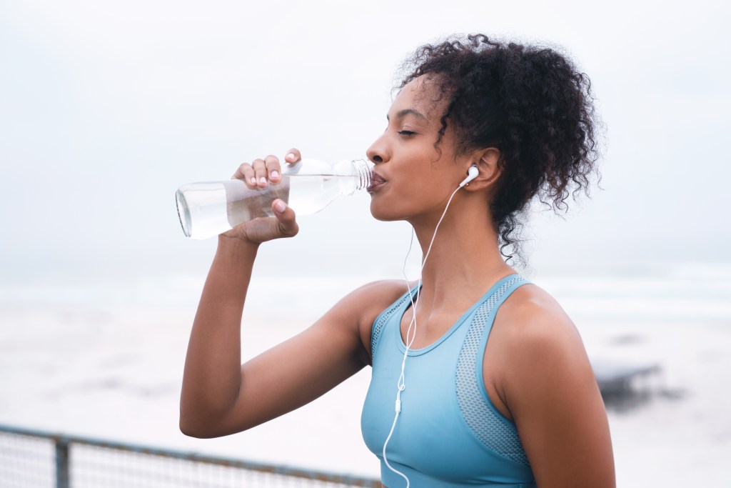 Woman staying hydrated after exercise
