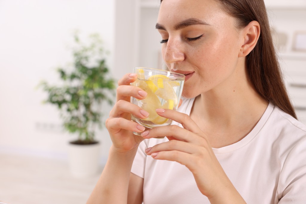 Woman drinking lemon water